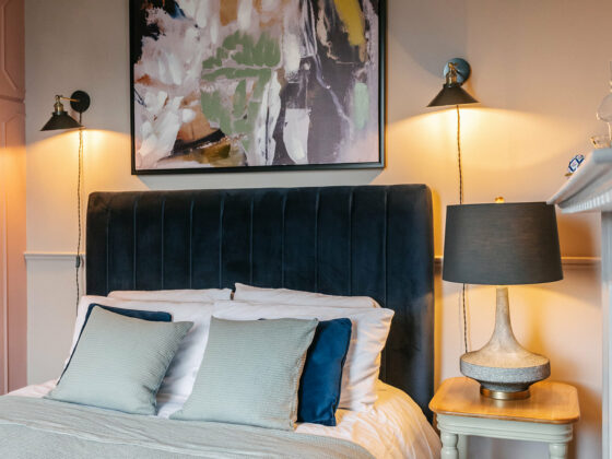 Navy blue bed styled in light blue bedding