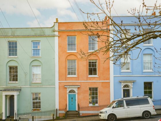 House fronts-outdoors-colourful terrace houses-white camper van-street view