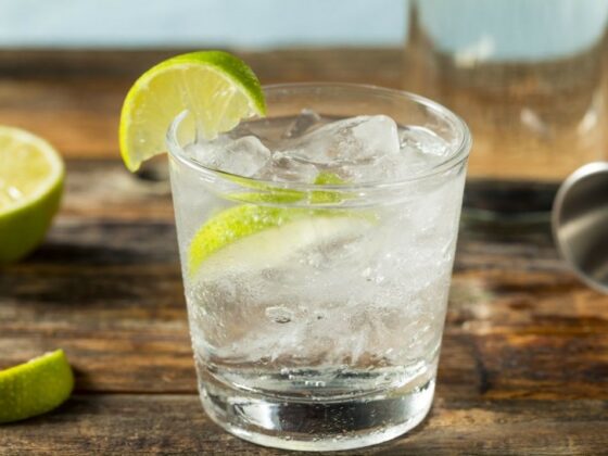 A glass-kitchen-gin and tonic-cocktail making-chopping board