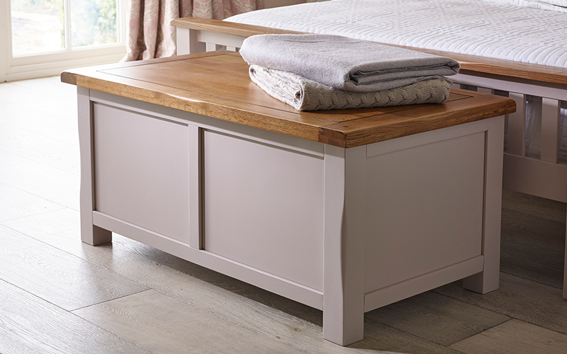 grey painted blanket box in neutral bedroom