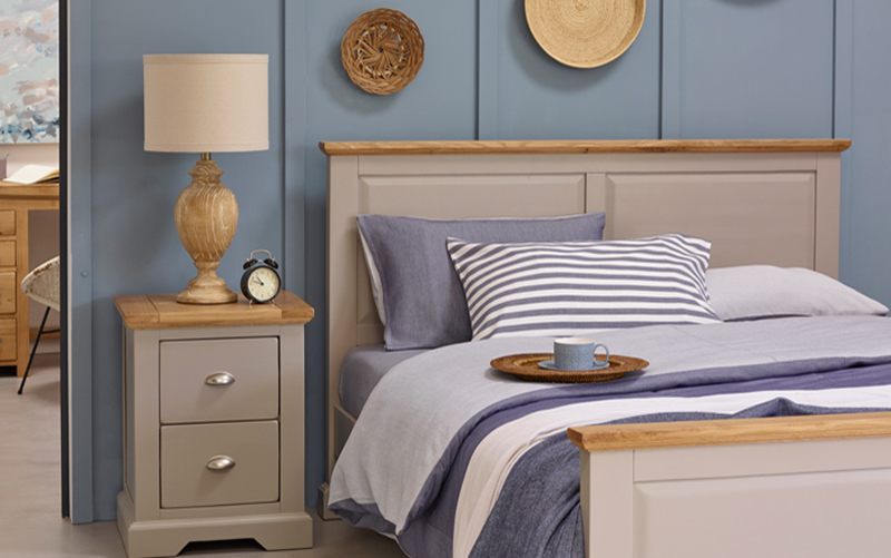 grey painted double bed with matching bedside table