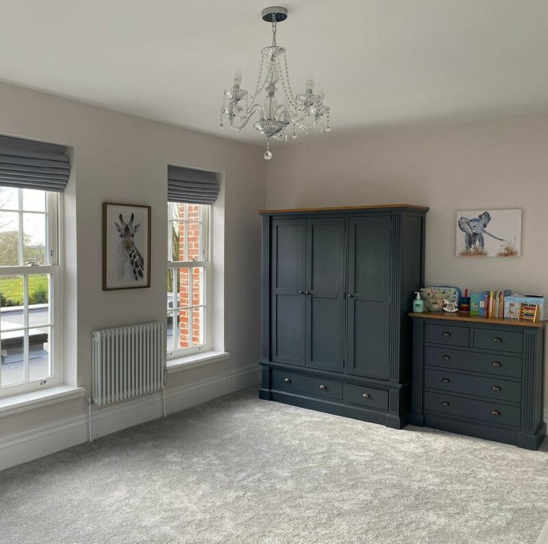 Blue painted triple wardrobe in neutral room