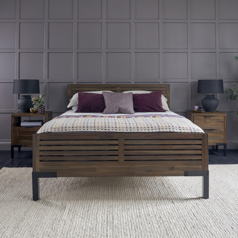 Dark wood King-Size bed and bedside tables against grey panelled walls.