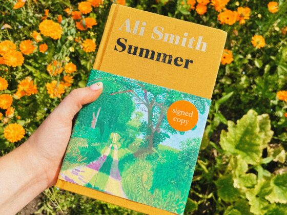 A book cover-hand holding book-wild flowers-summery book cover