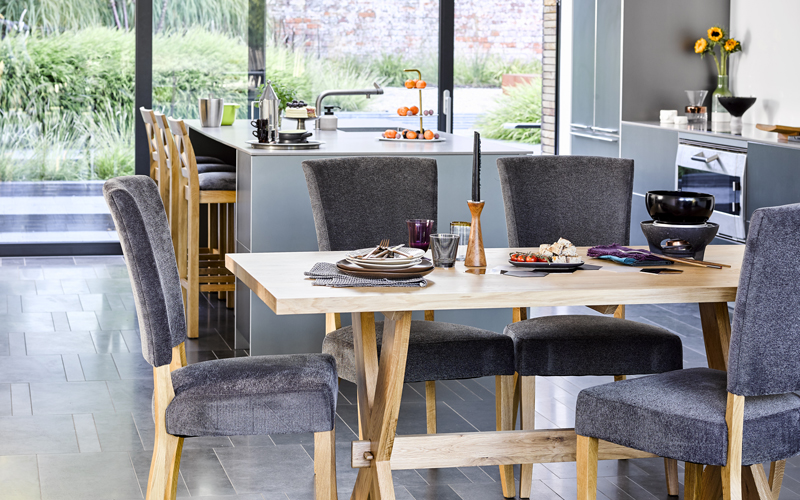 Oak table and chairs set in an open plan kitchen