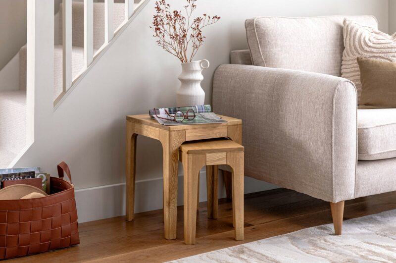 A nest of tables and armchair-living room furniture-wooden nest of tables and beige armchair