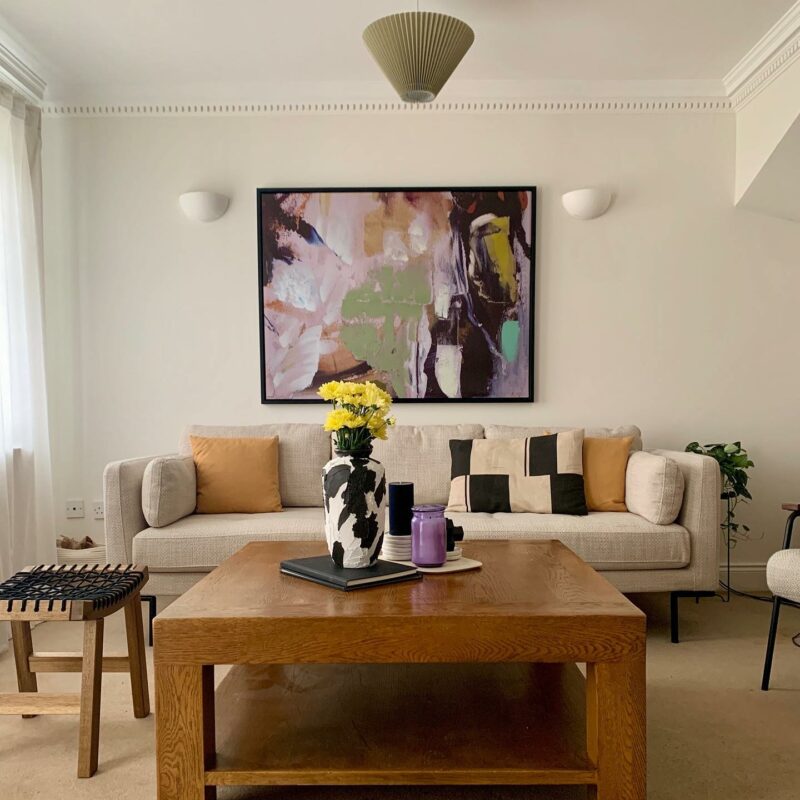 Oak Furnitureland Hope abstract colourful wall art in a living room above a cream retro sofa.