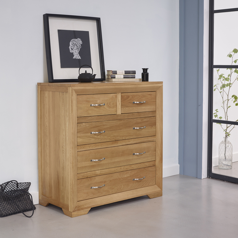 chest of drawers in bedroom with photo frame on top