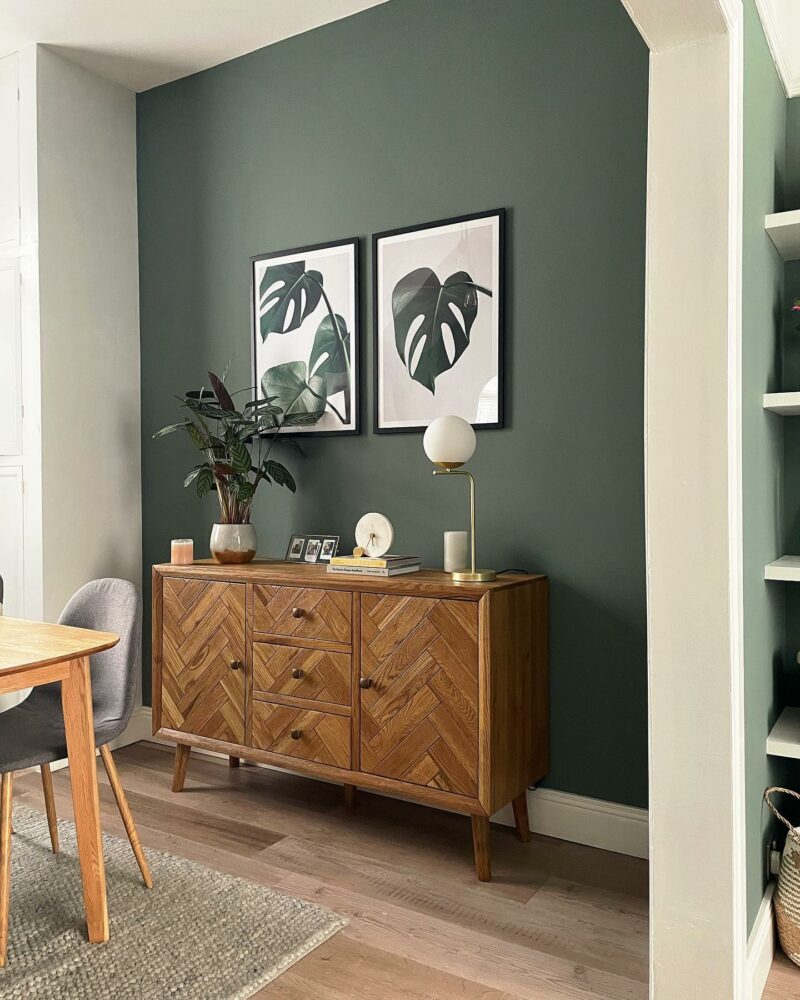 Parquet sideboard in green feature wall dining room