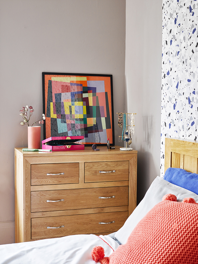 chest of drawers topped with colourful accessories